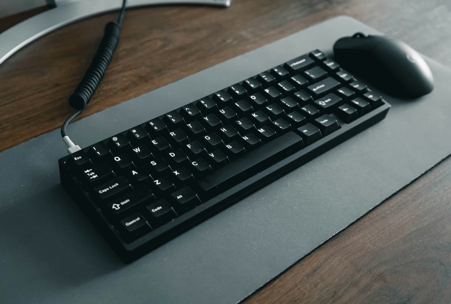 Hands typing on a compact mechanical keyboard from above